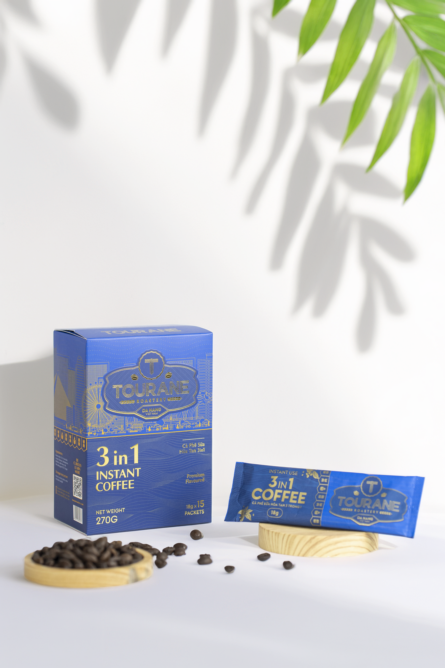 Tetley 3-in-1 instant coffee packaging with coffee beans on a white background